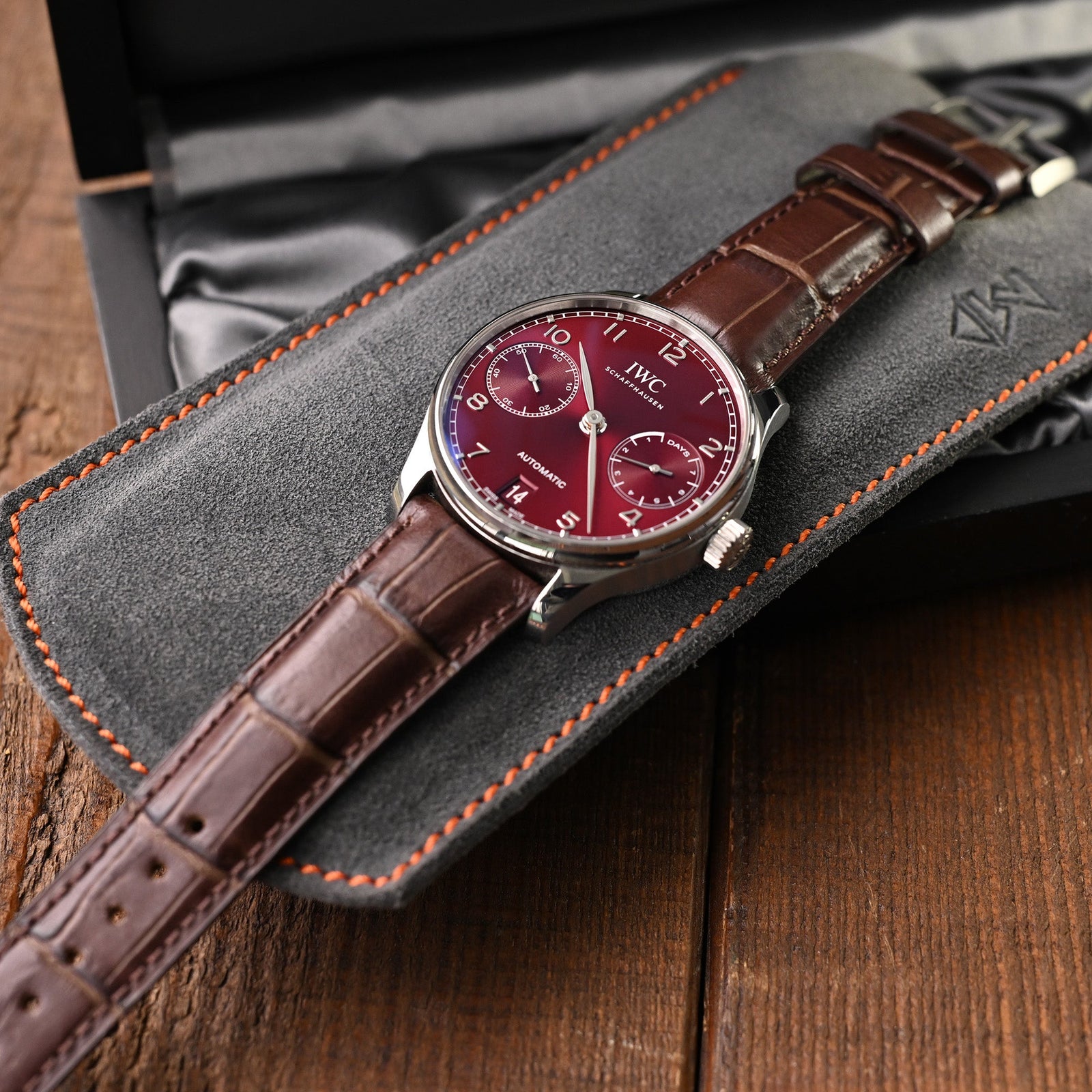 A watch with a brown leather strap